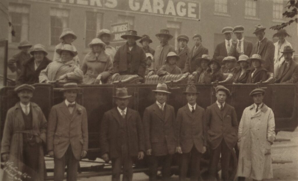 Celebrating Past In The Future: A Unique Journey Through Vintage Photographs british-men-and-women-near-lowtiers-garage